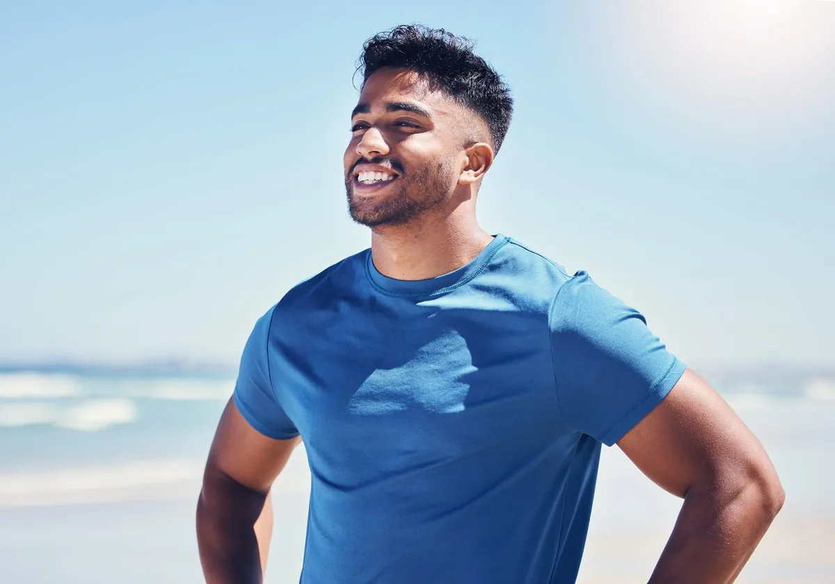 Man smiling during outdoor hike - testosterone replacement therapy treatment benefits