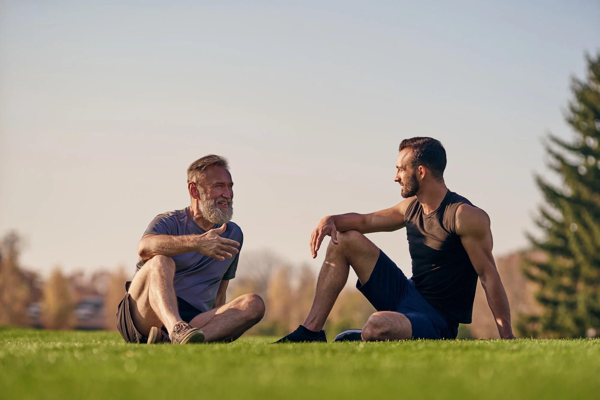 Man and son relaxing together in park - best testosterone replacement therapy clinic Cottleville